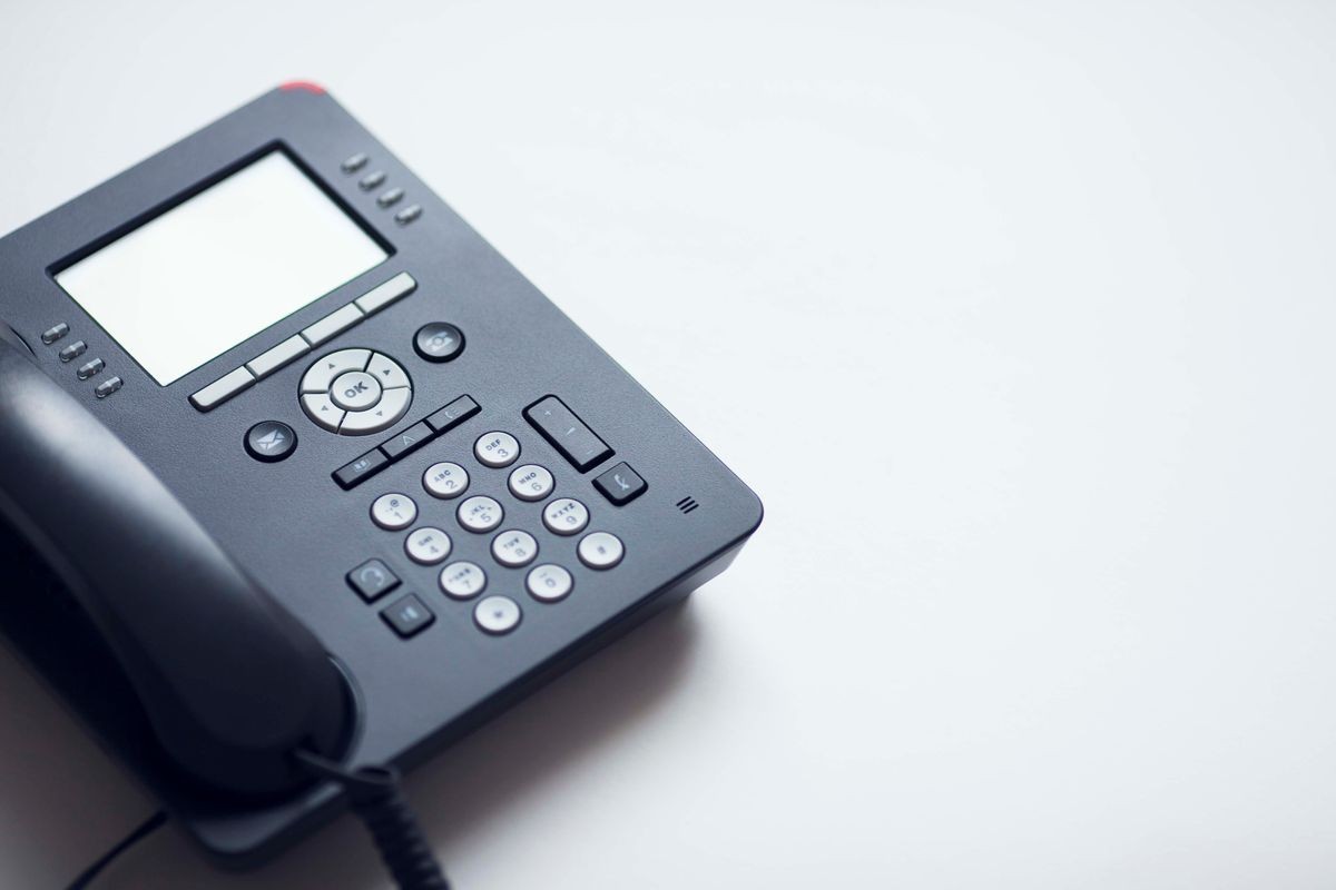 Deskphone, office and business concept. New ip phone with buttons and big display for communication without interference. Top view. Space for a text. Close up.